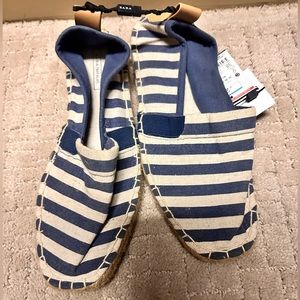 Navy and white slide on shoes.